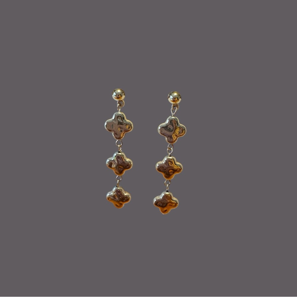 Pair of Gold colored post back earrings with 3 dangling clover shapes. NWOT